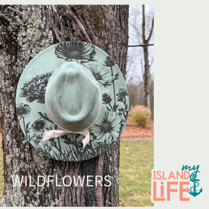 Green hat with floral pattern attached to a tree, with 'My Island Life' branding.