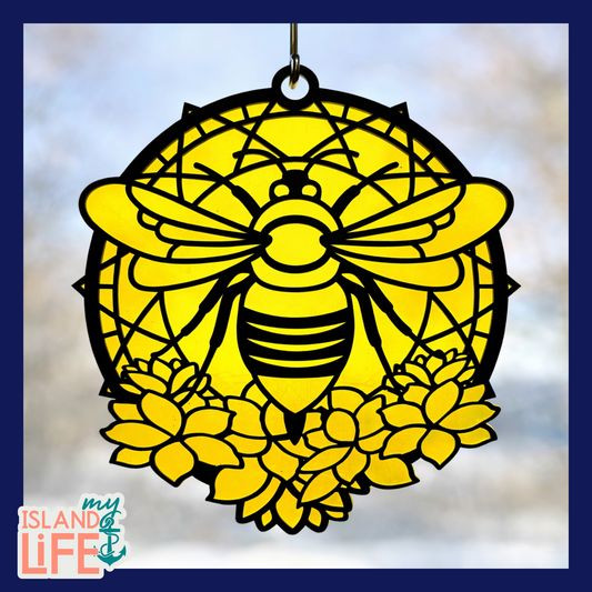 Decorative pink and black bird design with a suction cup on a light blue background.