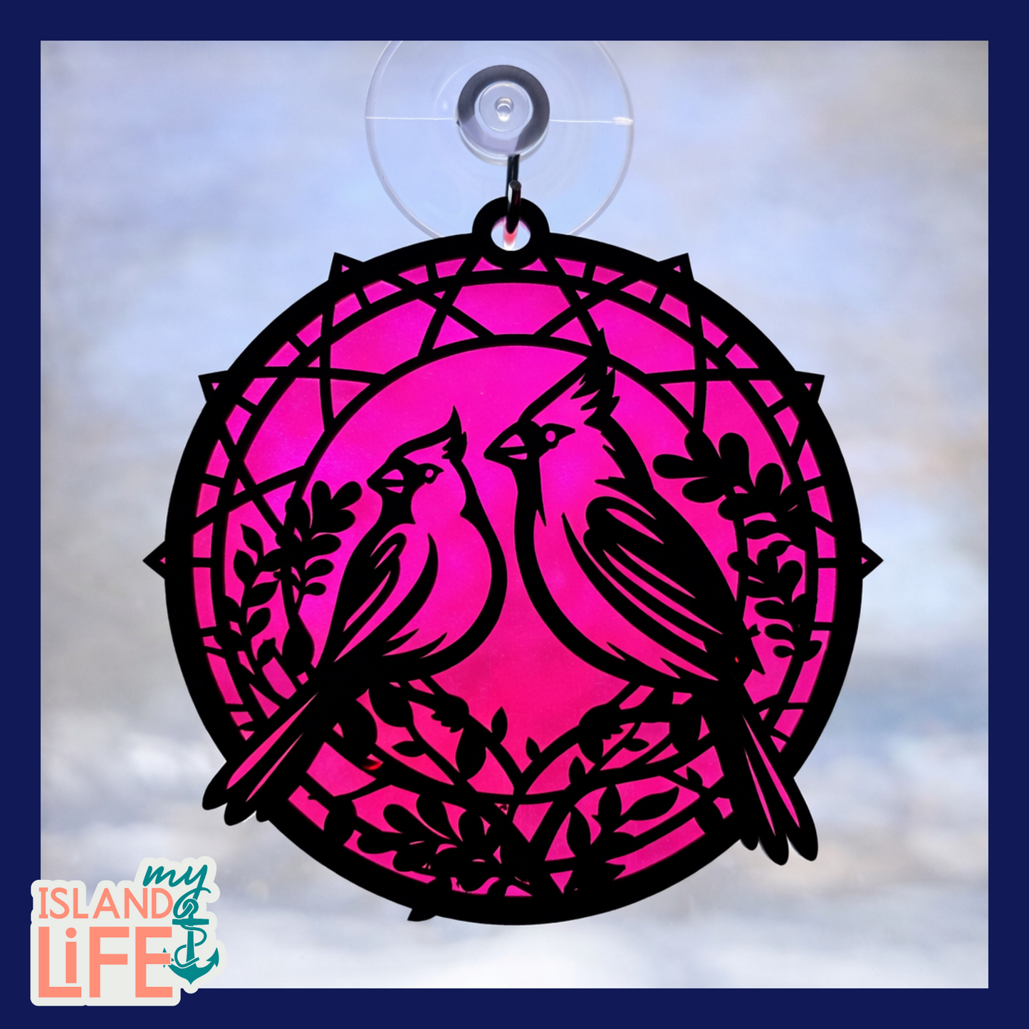Decorative pink and black bird design with a suction cup on a light blue background.