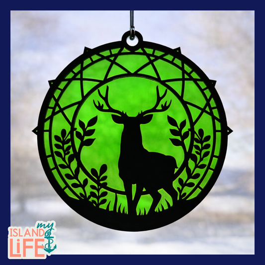 Decorative circular hanging with a deer silhouette on a green background, featuring 'my ISLAND life' logo.