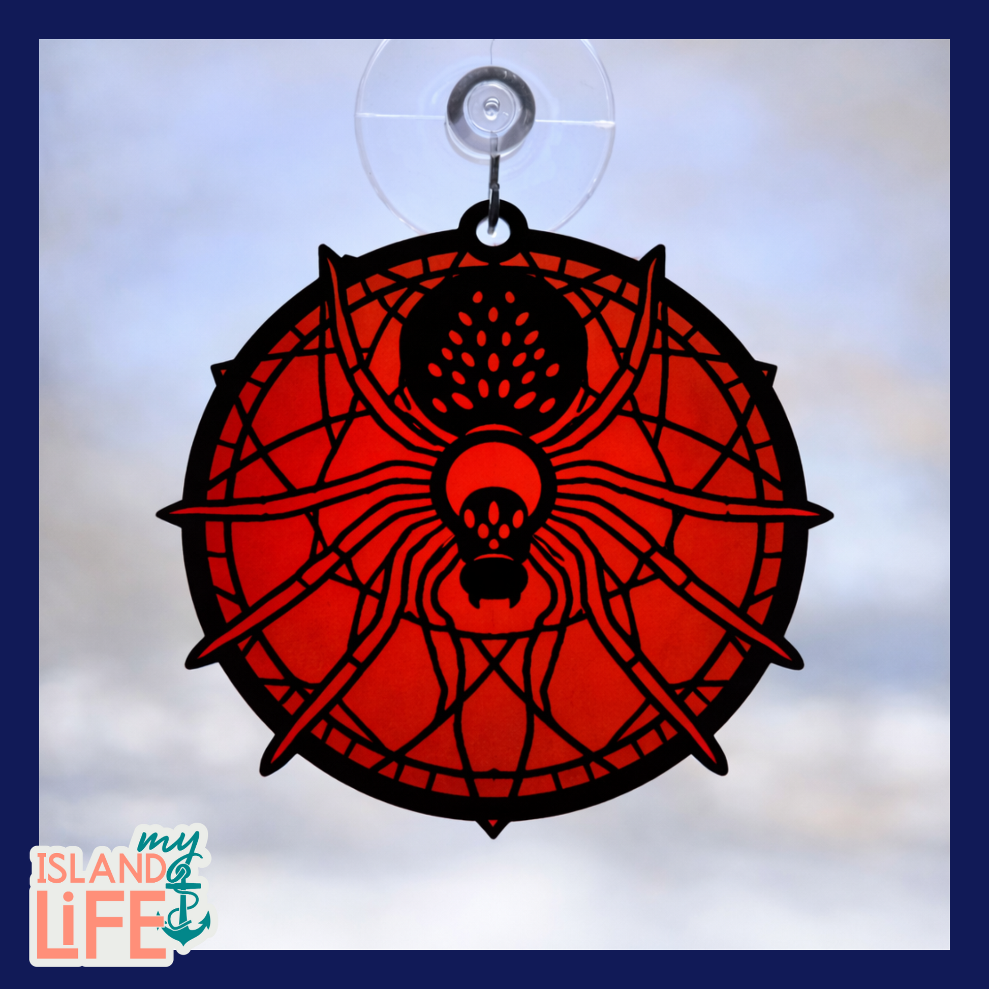 Decorative window hanging with spider design on a white background, featuring 'my ISLAND life' logo.