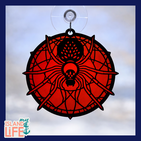 Decorative window hanging with spider design on a white background, featuring 'my ISLAND life' logo.