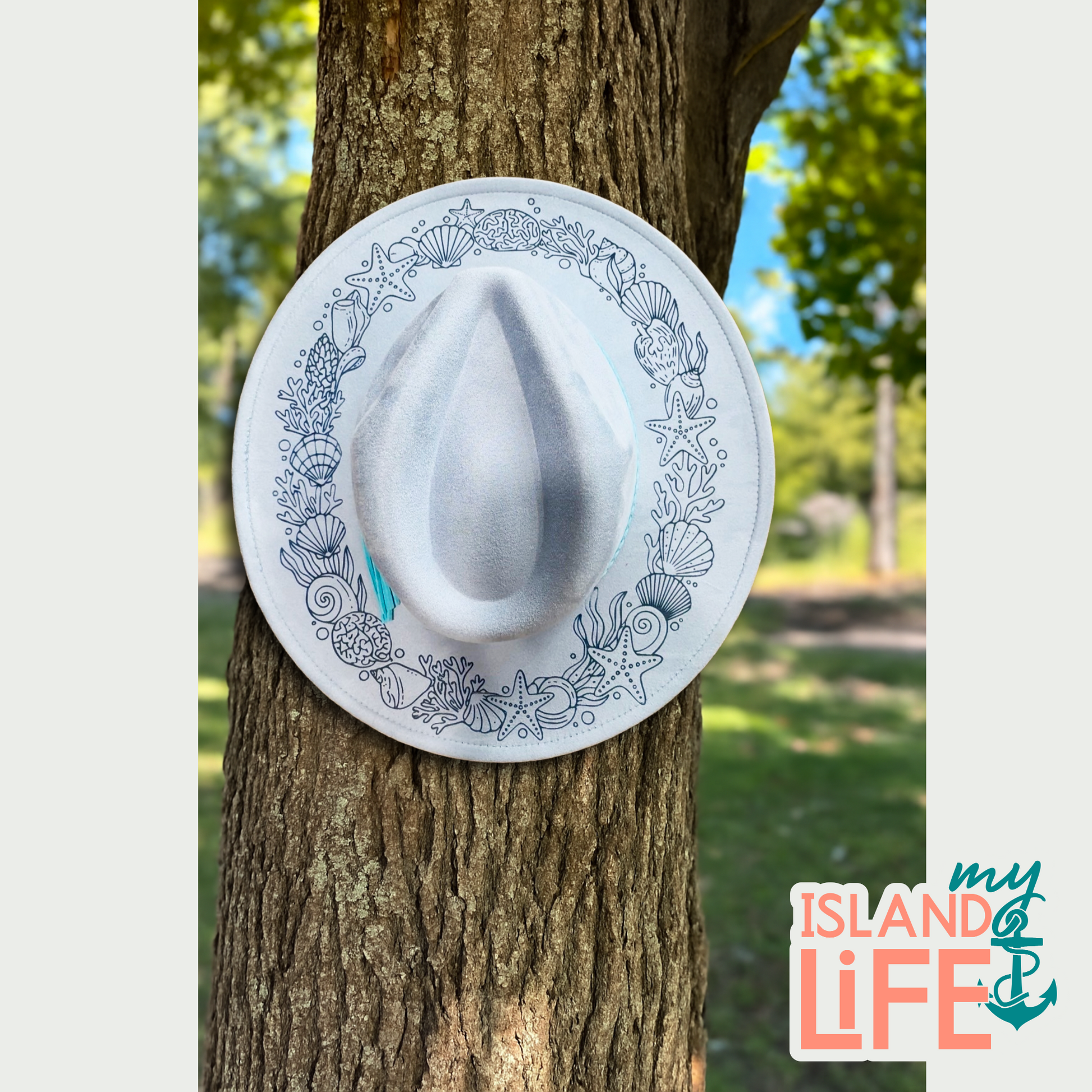 Decorative hat with shell pattern attached to a tree, 'my ISLAND LIFE' logo visible